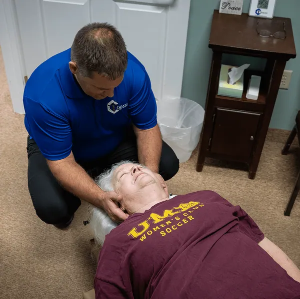 Chiropractor performing a cervical adjustment