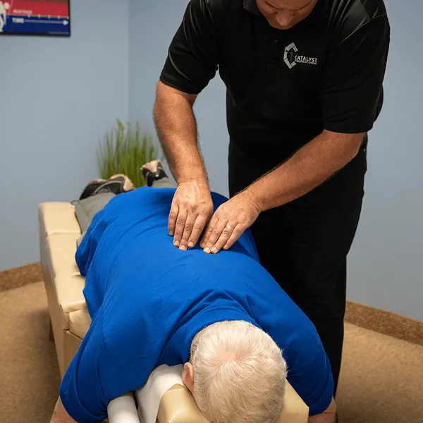 Chiropractor adjusting a patient’s mid back
