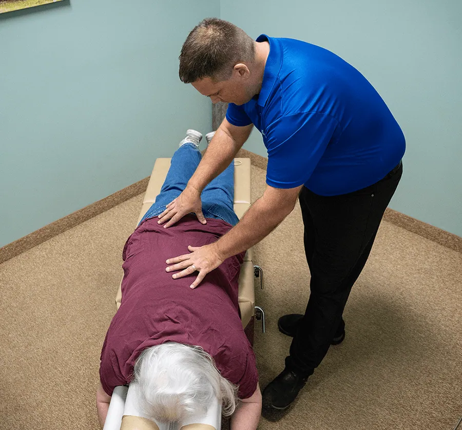 Chiropractor adjusting a patient’s lower back at Catalyst Chiropractic and Rehab