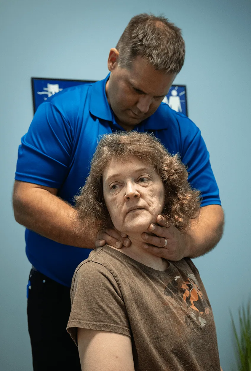 Chiropractor performing a neck adjustment