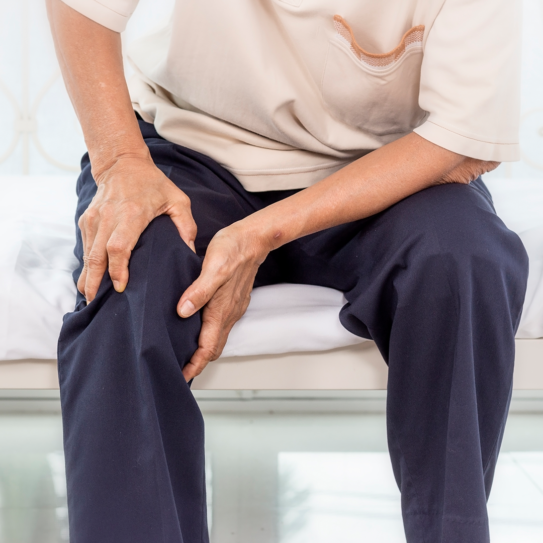 man touching leg due to pain